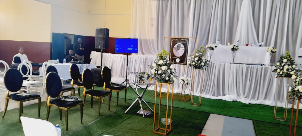 Draped funeral service venue with flowers